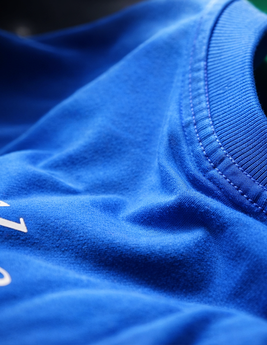 Close-up of a blue fabric texture with a brand logo.