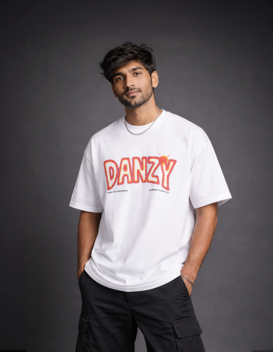 Person wearing a white t-shirt with 'DANZY' printed on it against a dark background