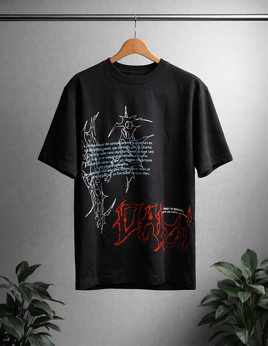 Black t-shirt with graphic designs on a hanger against a gray background