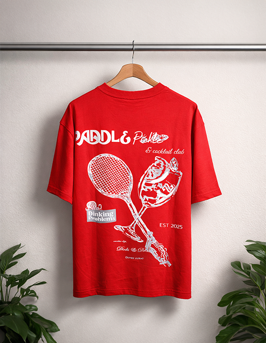 Red t-shirt with white graphics and text on a hanger against a light gray background